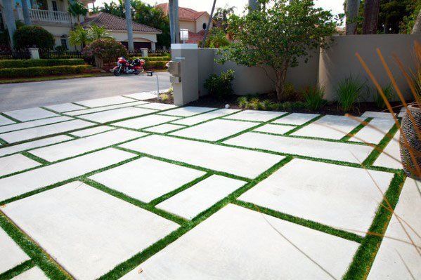 artificial turf laid between concrete pavers to create a unique driveway in Arizona