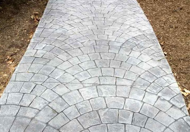 concrete scraper is used to create a smooth-finished walkway