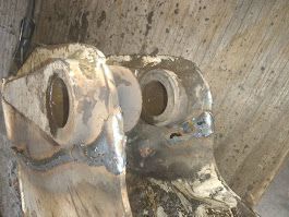 A close up of a piece of metal on a wooden table.
