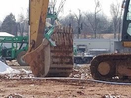 A bulldozer is moving dirt on a construction site.