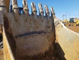 A close up of the teeth of a bulldozer bucket.