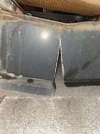 A piece of metal is sitting on top of a concrete floor.