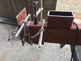 A close up of a piece of metal with a pair of pliers attached to it.