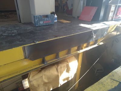 A large piece of wood is sitting on top of a table in a room.