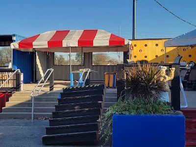 A red and white striped awning is sitting on top of a building.