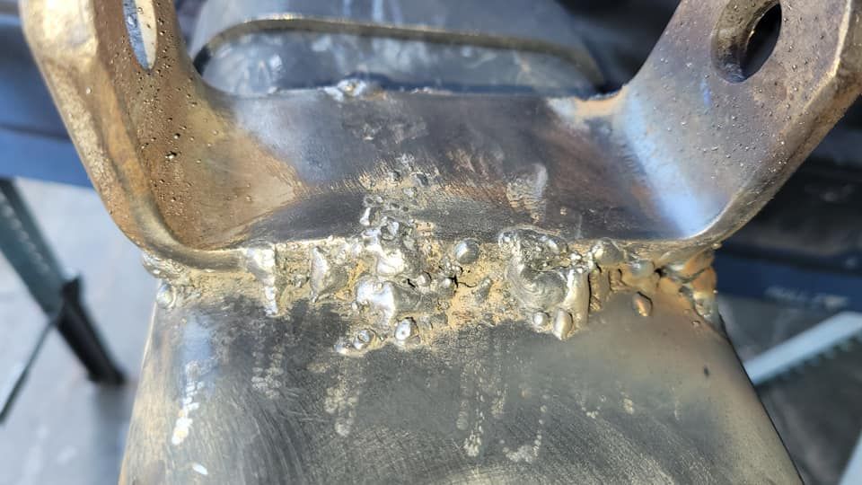 A close up of a metal object with a lot of rust on it.