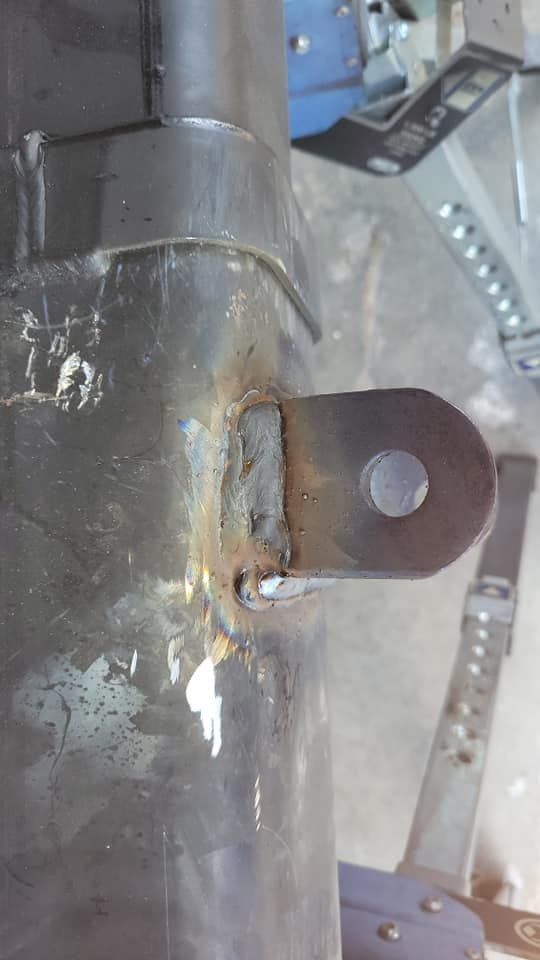 A close up of a rusty metal pipe with a hole in it.