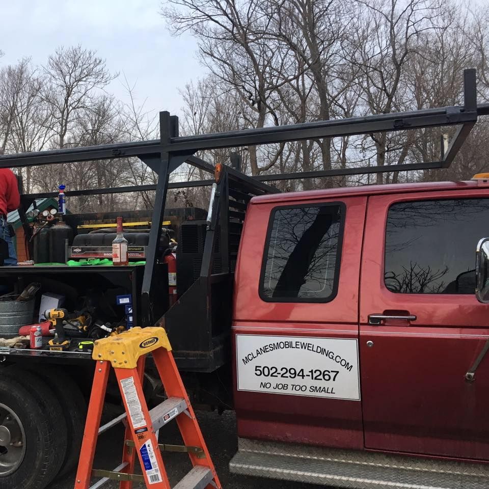 A red van with the phone number 502-294-1267 on the side