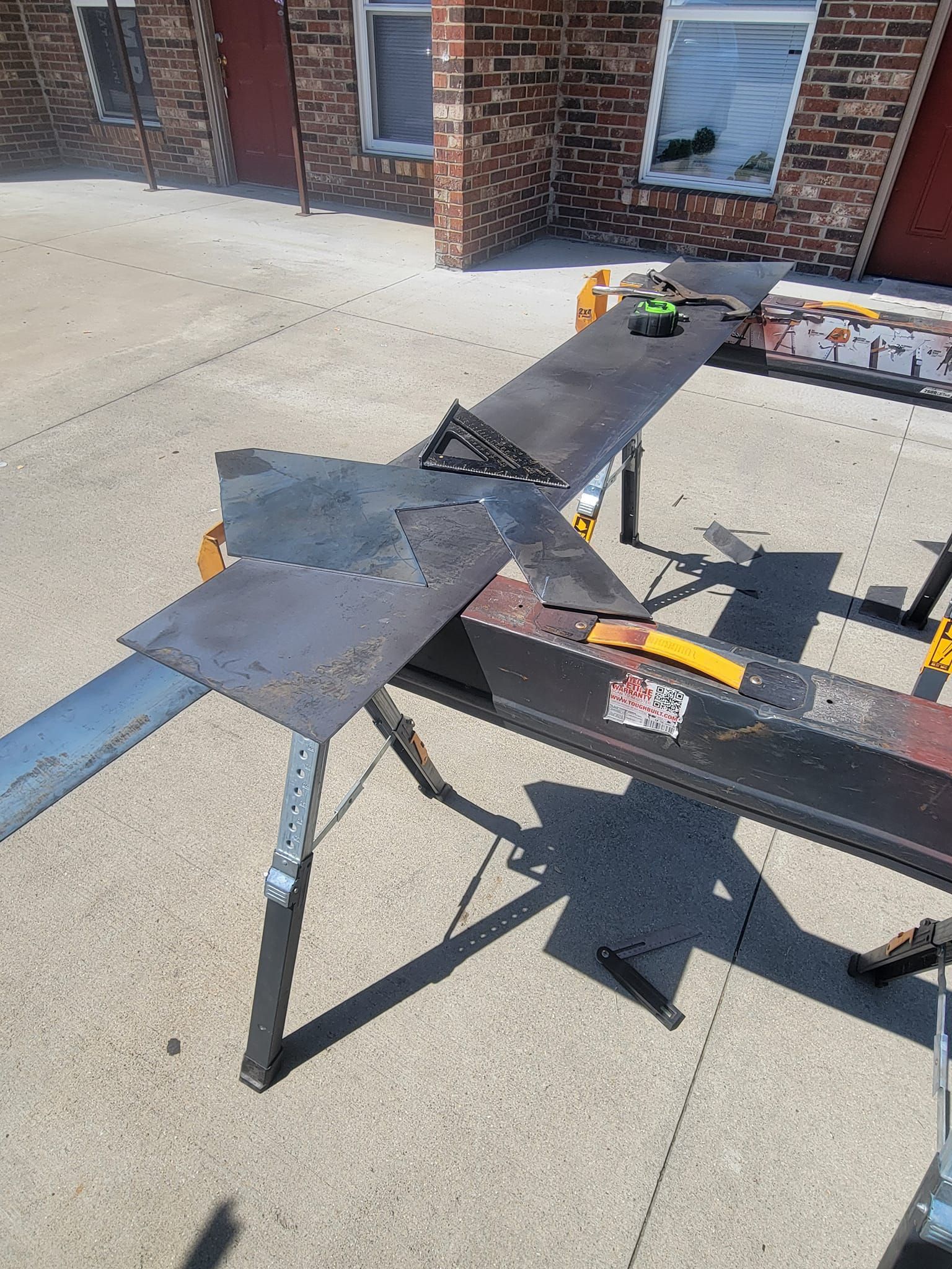 A piece of metal is sitting on top of a metal workbench.
