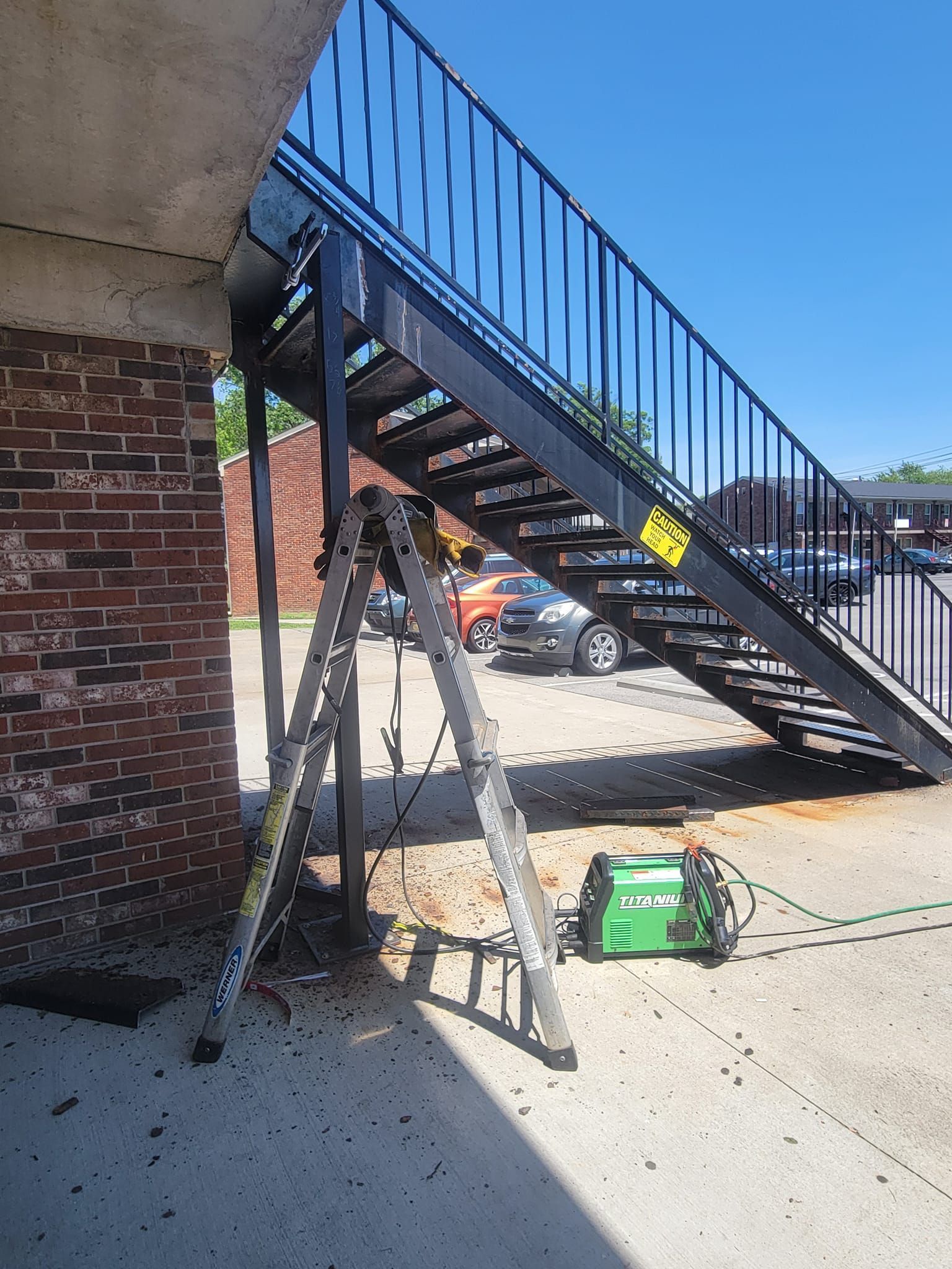 A ladder is sitting next to a set of stairs