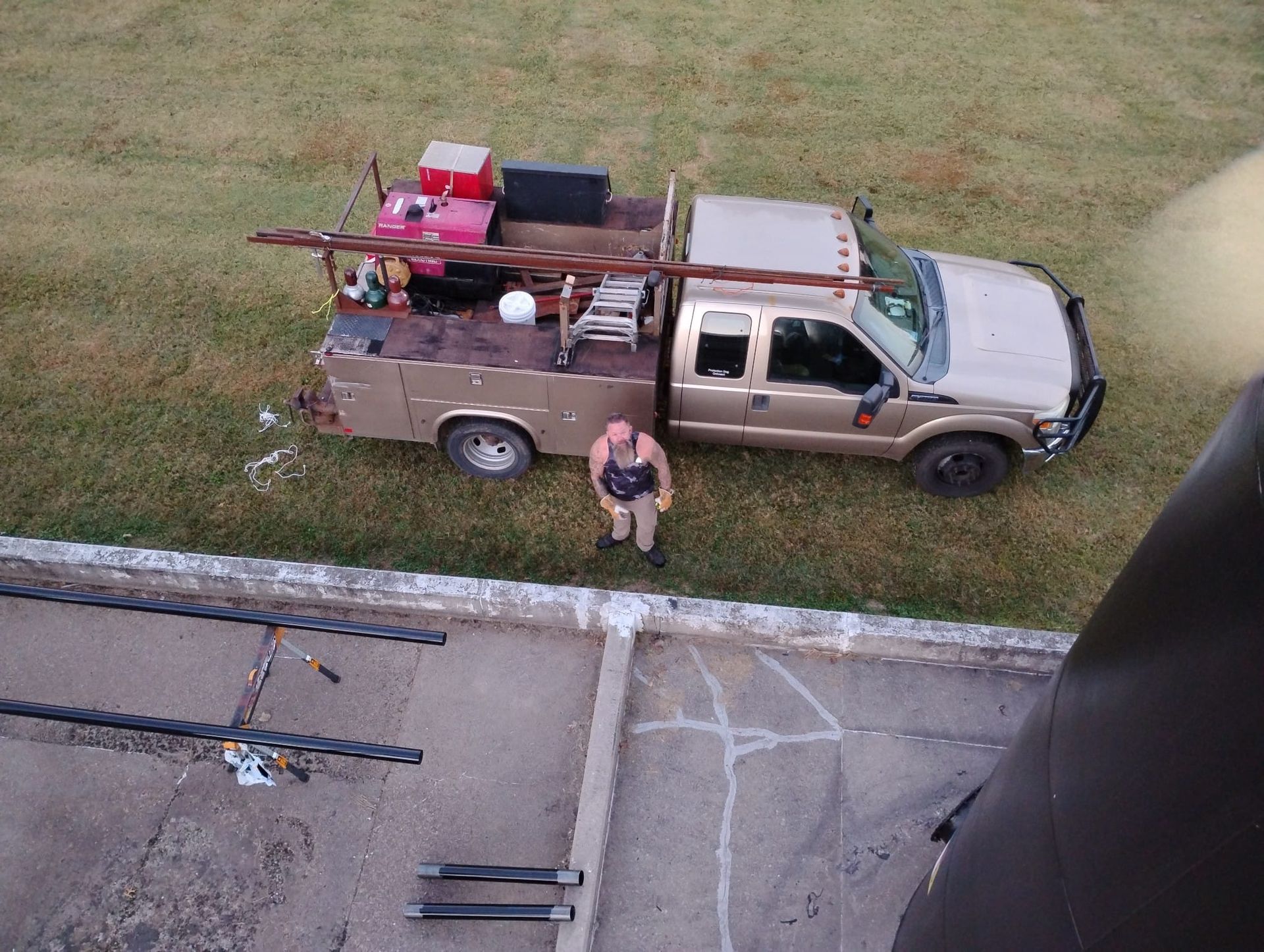 A man standing next to a truck with a ladder on the back