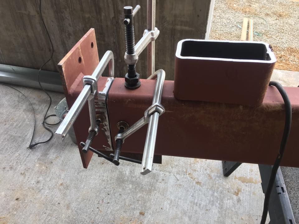 A piece of metal with a clamp attached to it