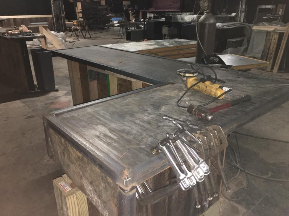 A wooden table with a bunch of tools on it