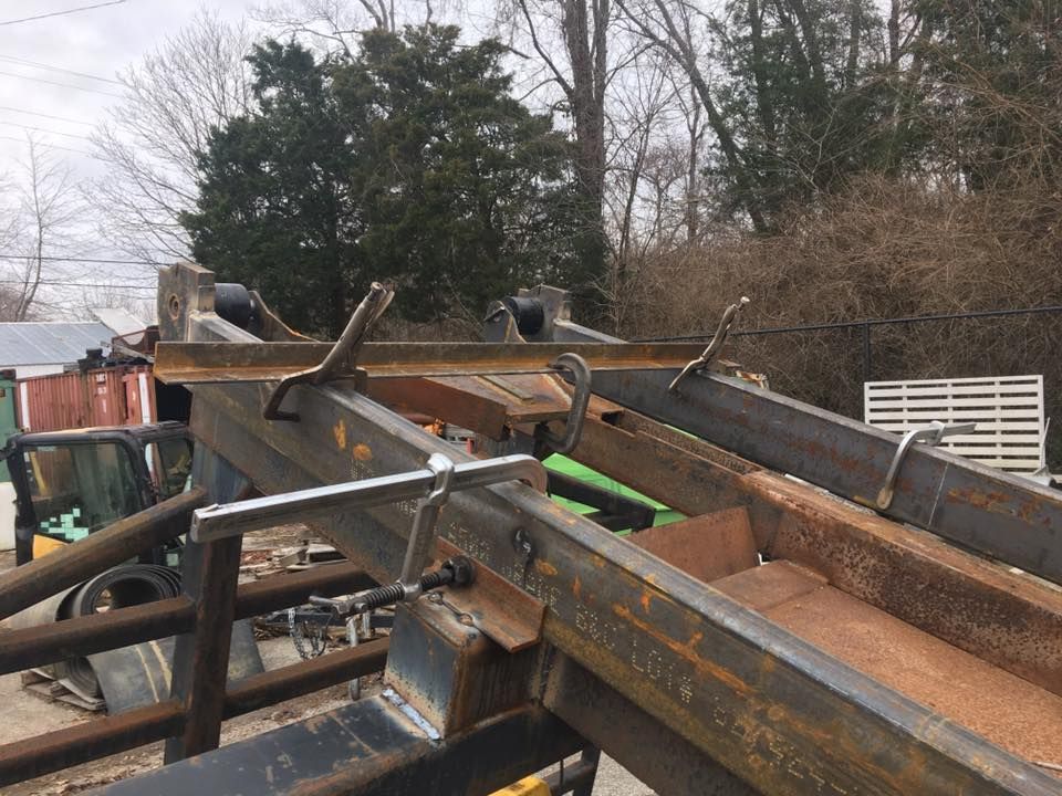 A bunch of metal pieces are sitting on top of each other in a yard.