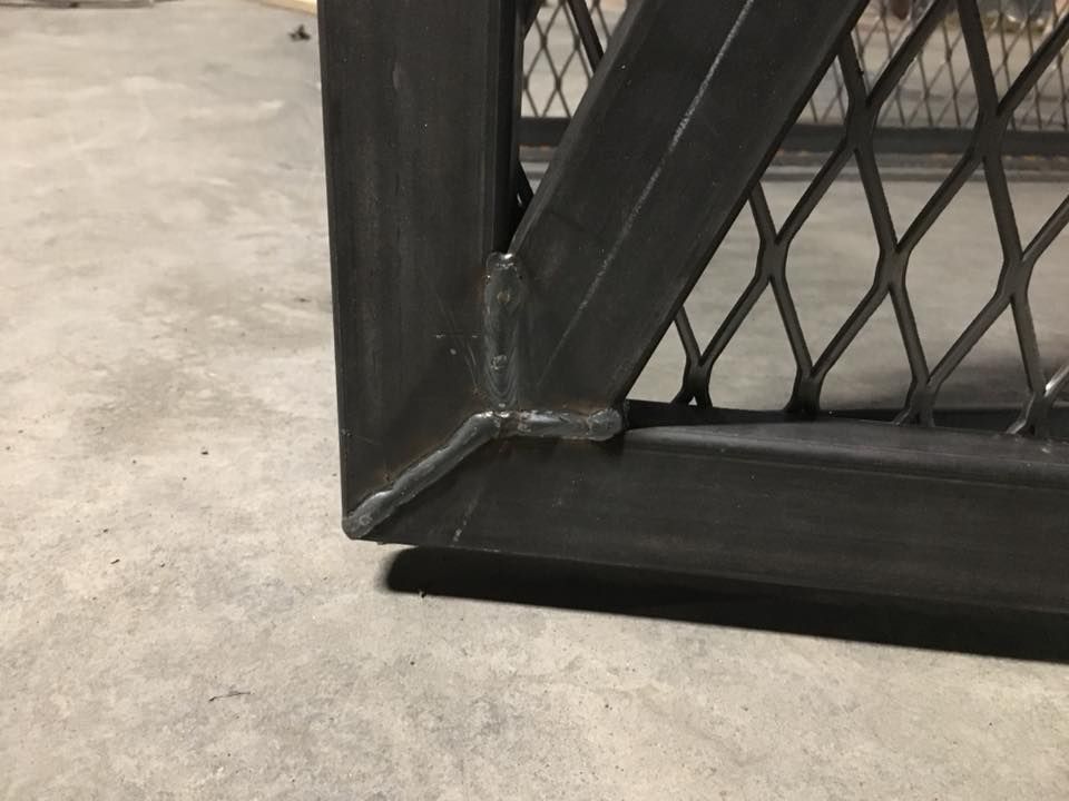 A close up of a metal fence on a concrete floor