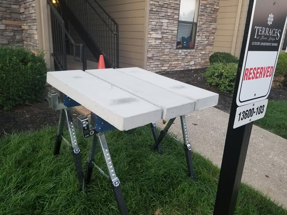 A table is sitting in the grass next to a sign that says reserves