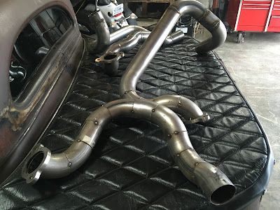 A bunch of exhaust pipes are sitting on top of a bed.