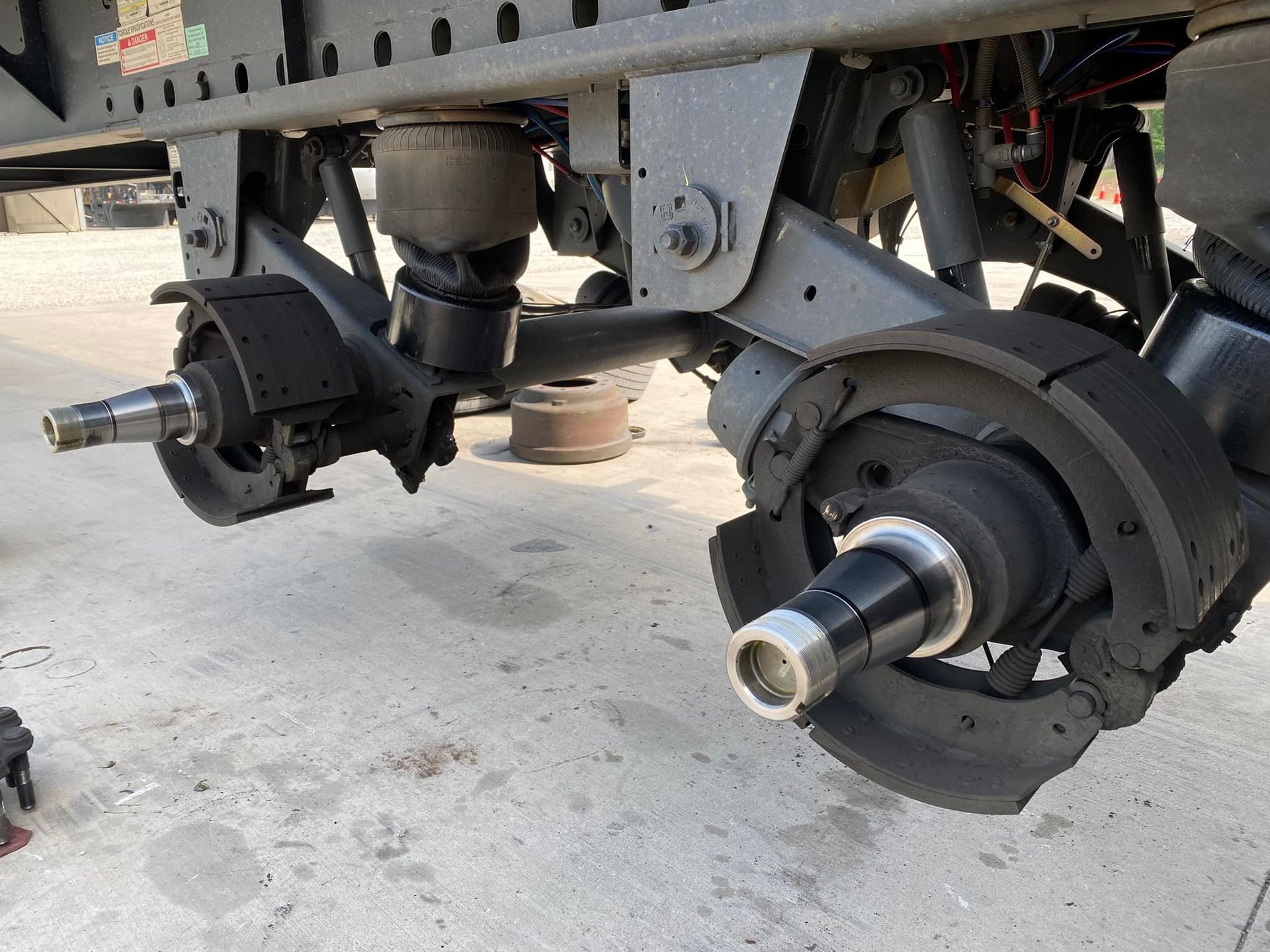 A close up of the underside of a truck 's brake system