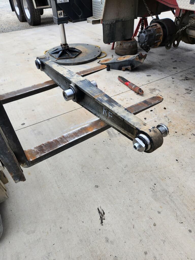 A piece of metal is sitting on the ground next to a truck.