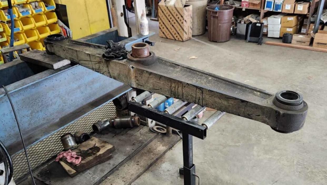 A large piece of metal is sitting on top of a table in a garage.