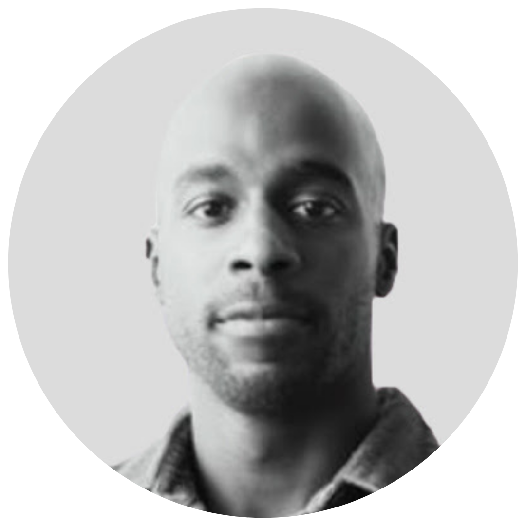 A woman wearing glasses and a yellow sweater is standing in front of a brown wall. A woman wearing glasses and a yellow sweater is standing in front of a brown wall.