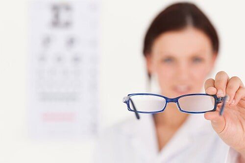 Blurred-optician-showing-glasses-in-1613-Owen-Dr-Fayetteville-NC-28304