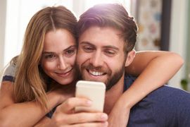 young couple looking at smart phone