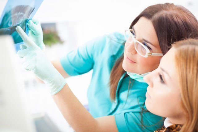 dentist consulting patient over xray results