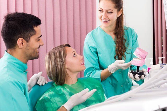 dentist informing patient of dental process