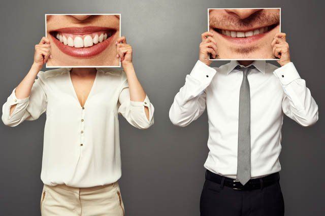 man and woman with zoomed pics of smiles