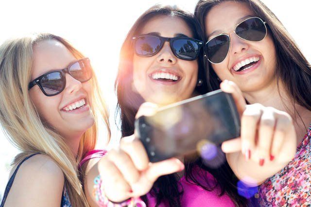 three young woman taking selfie