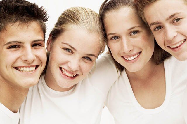 young smiling teens dressed in white