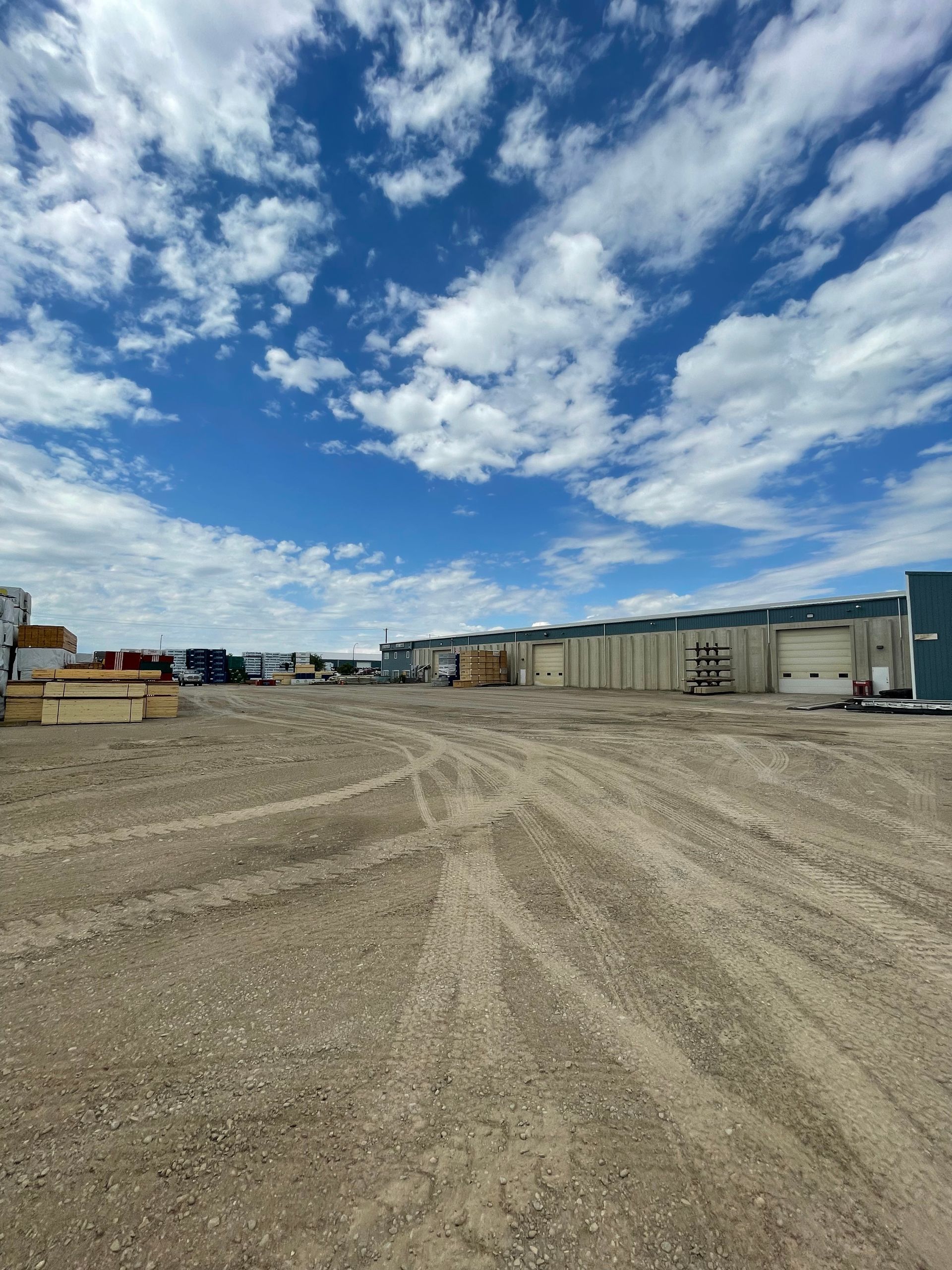 A large dirt field with a building in the background