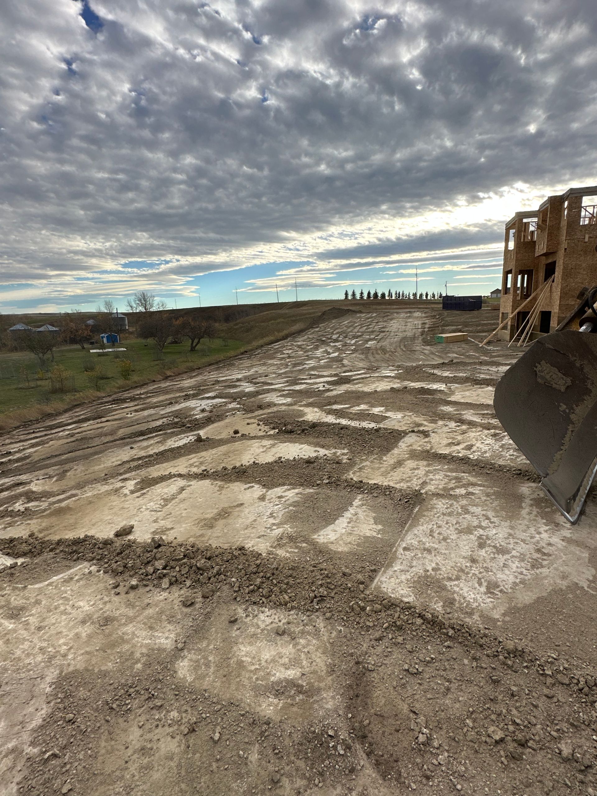 A bulldozer is moving dirt on a dirt road.
