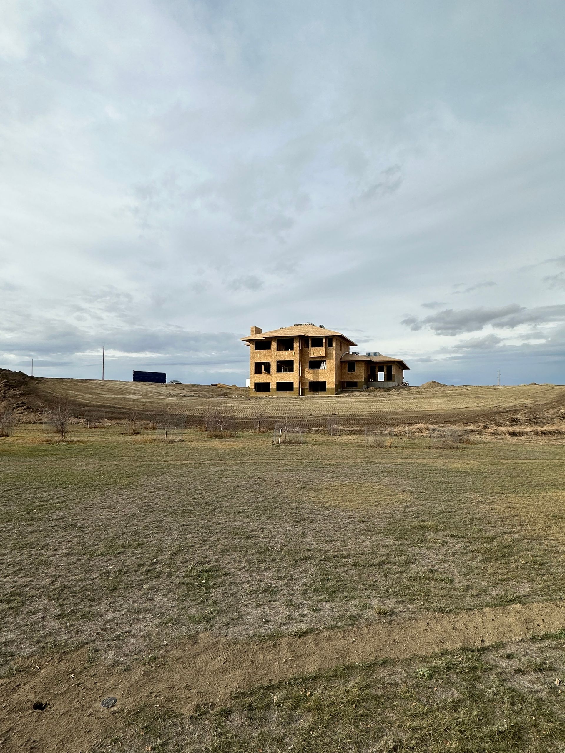 A house is being built in the middle of a field.