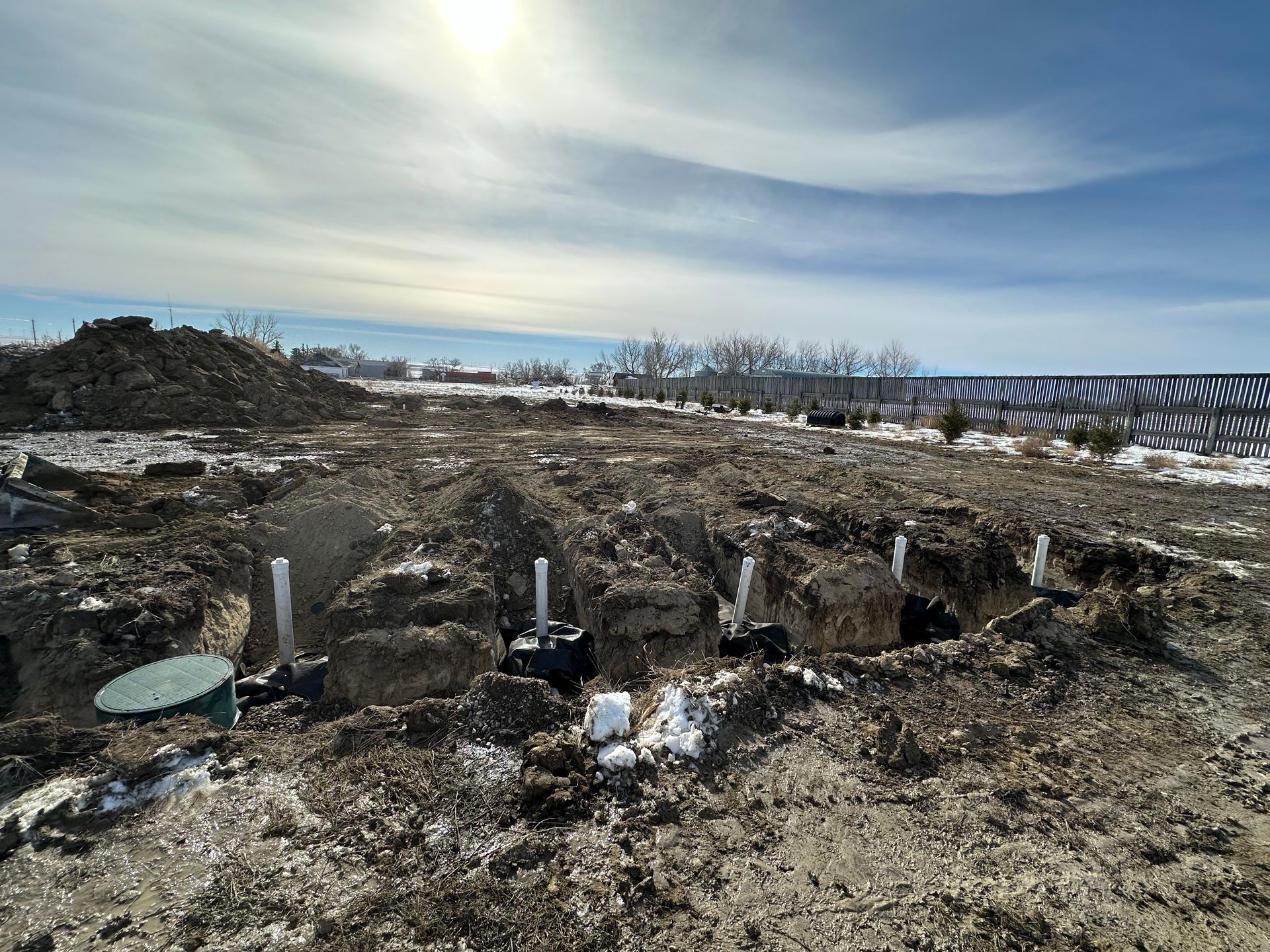 A large pile of dirt is sitting in the middle of a field.