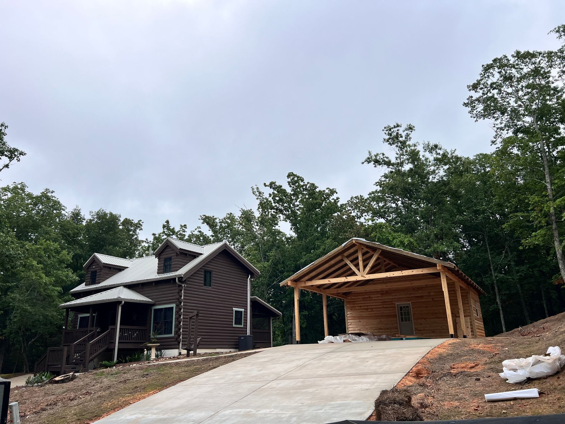A large log cabin is being built in the middle of a forest.