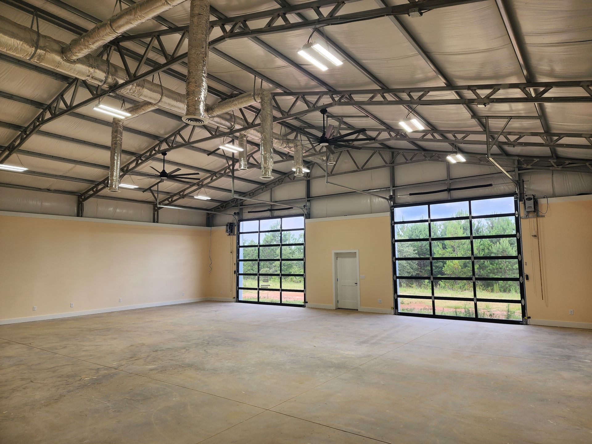A large empty warehouse with a large garage door.