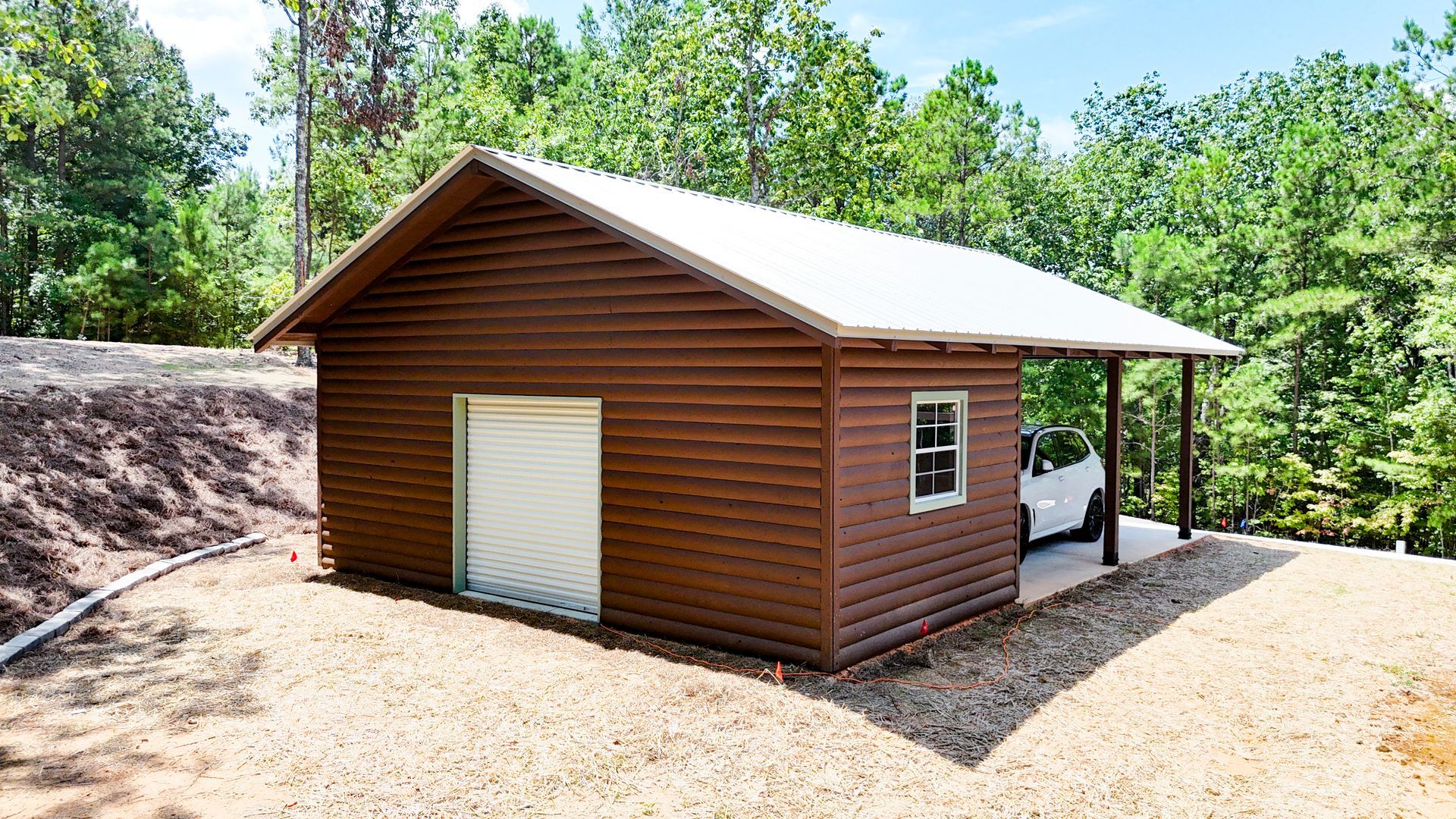 A wooden garage with a white truck parked underneath it.
