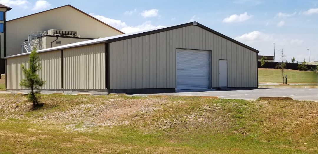 A large metal building with a white garage door