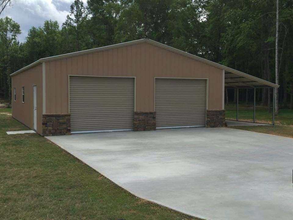 A garage with two garage doors and a concrete driveway