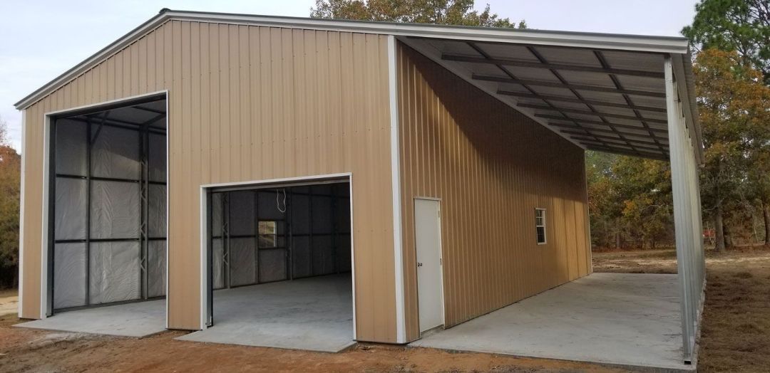 A large metal building with two garage doors and a canopy.
