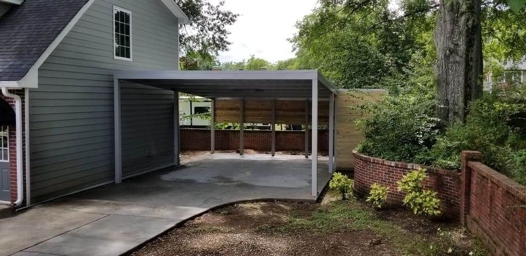 A carport is attached to the side of a house.