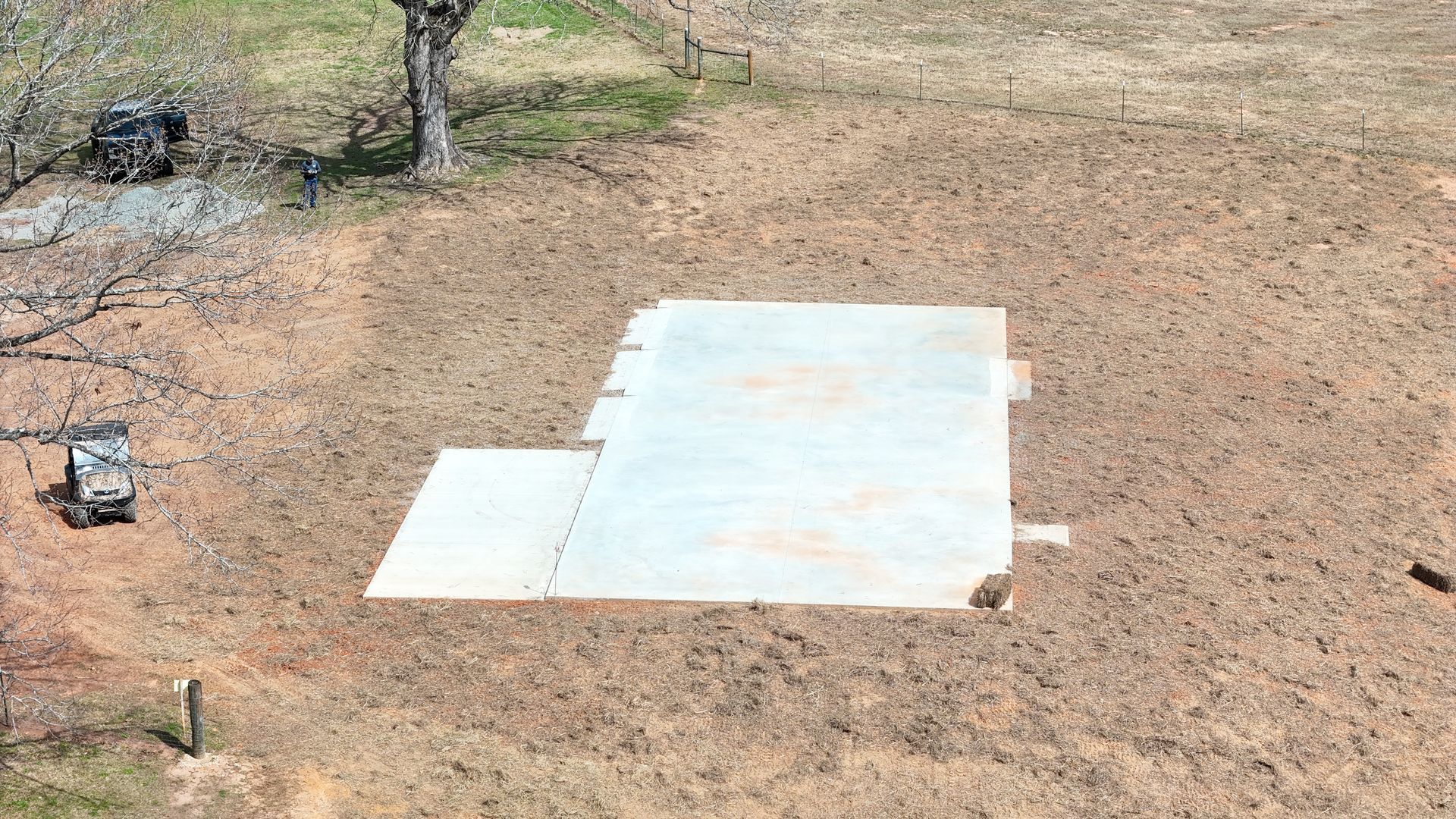 A large piece of concrete is sitting in the middle of a field.