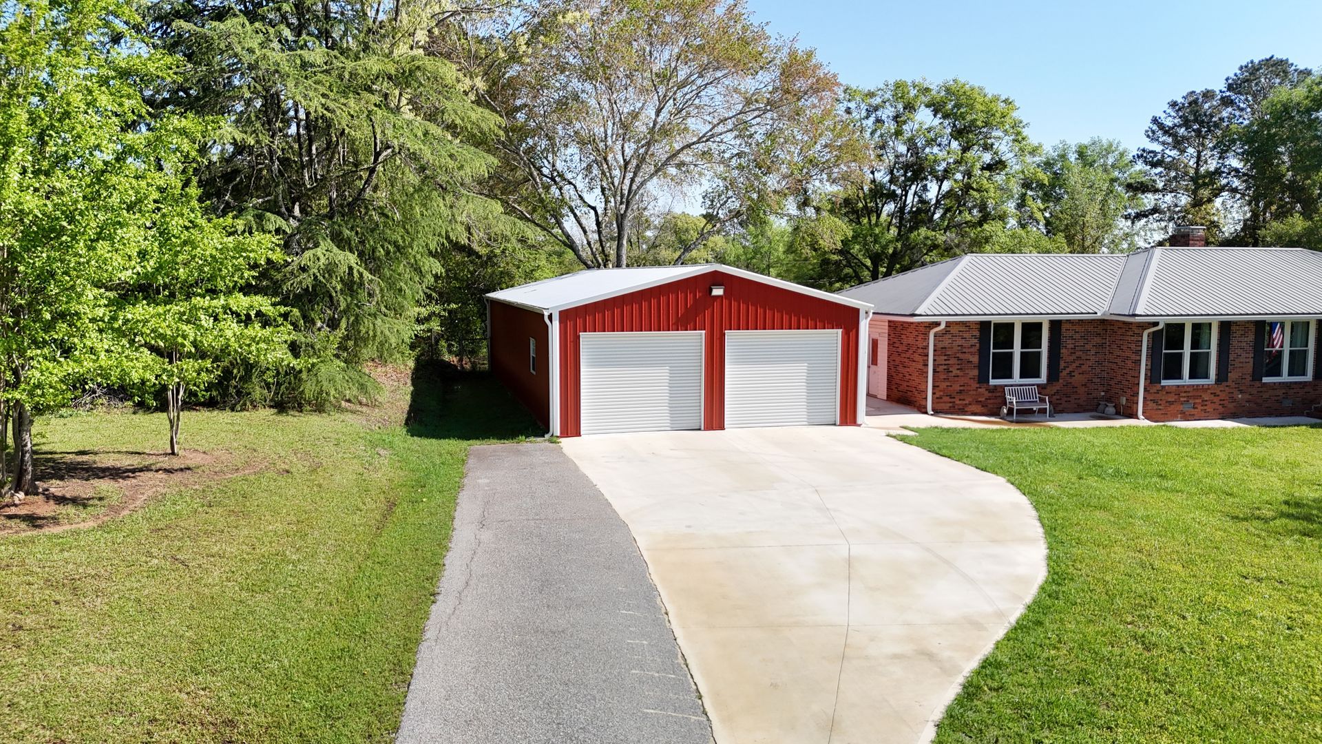 A brick house with a red garage and a driveway