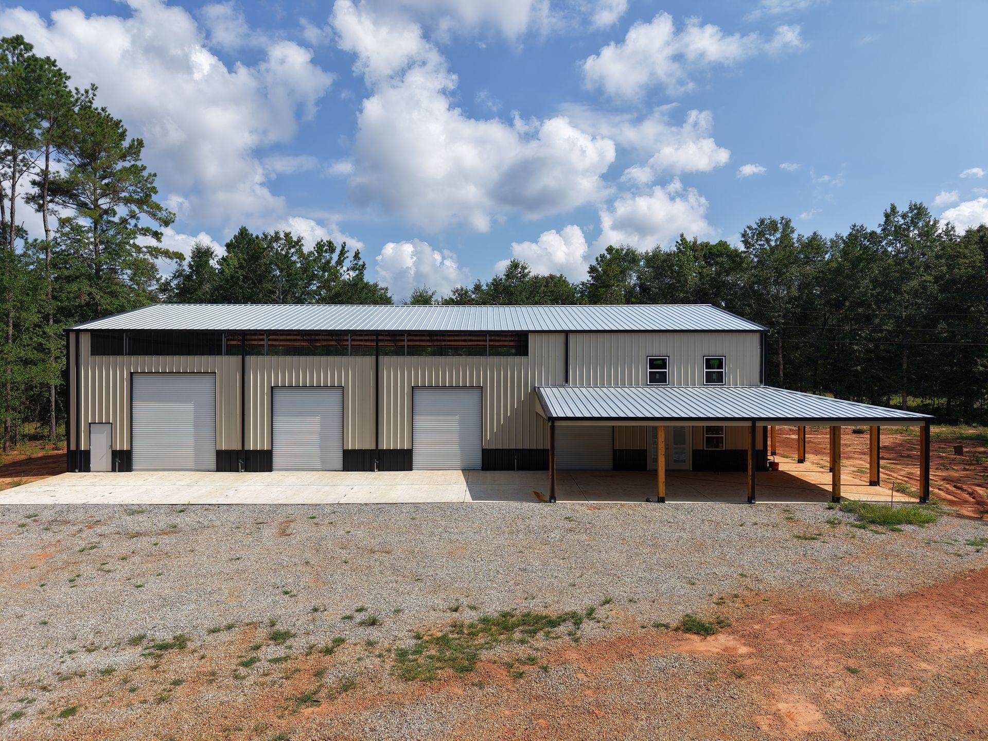 A large metal building with a carport underneath it