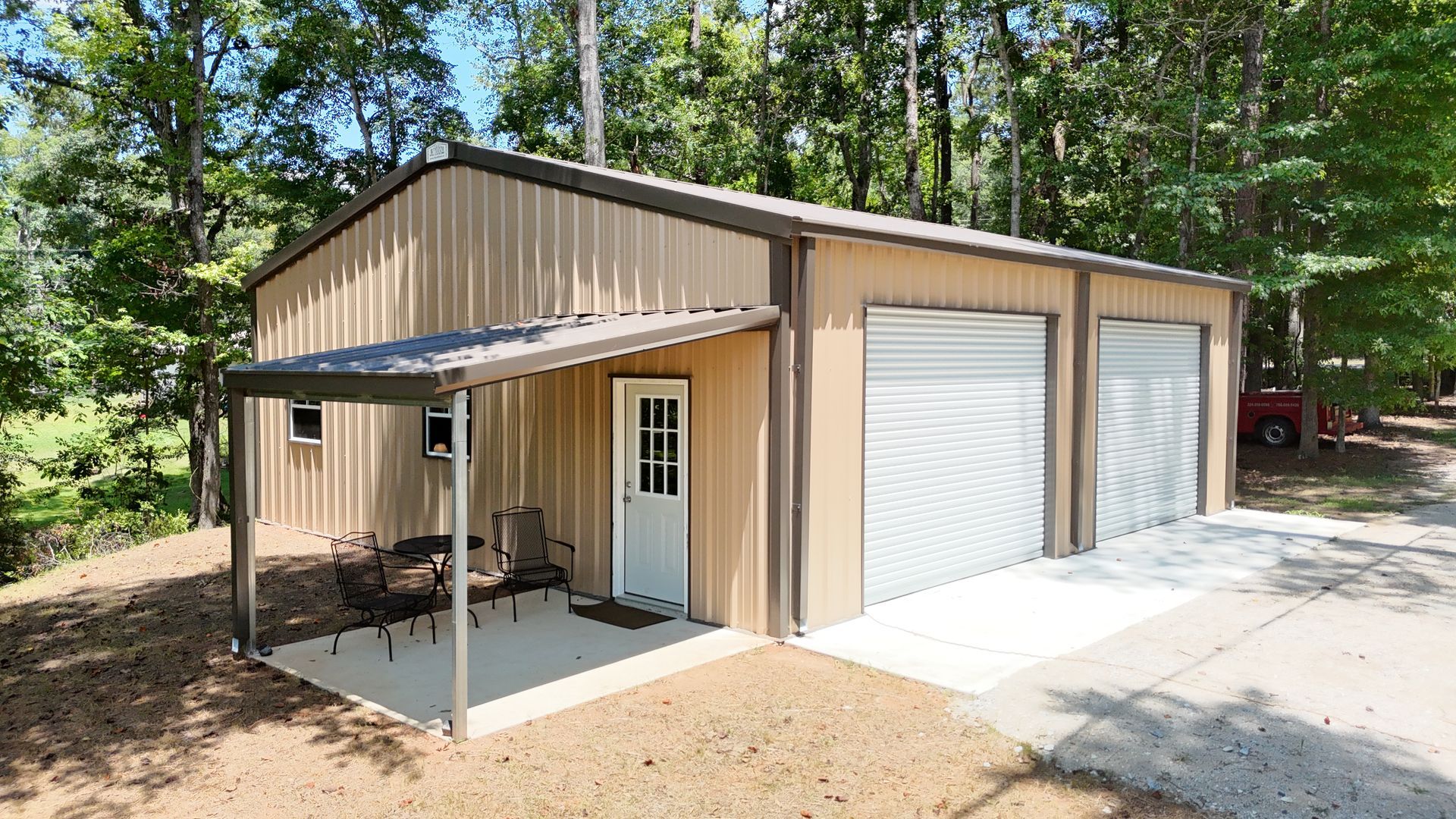 A garage with a porch and two garage doors