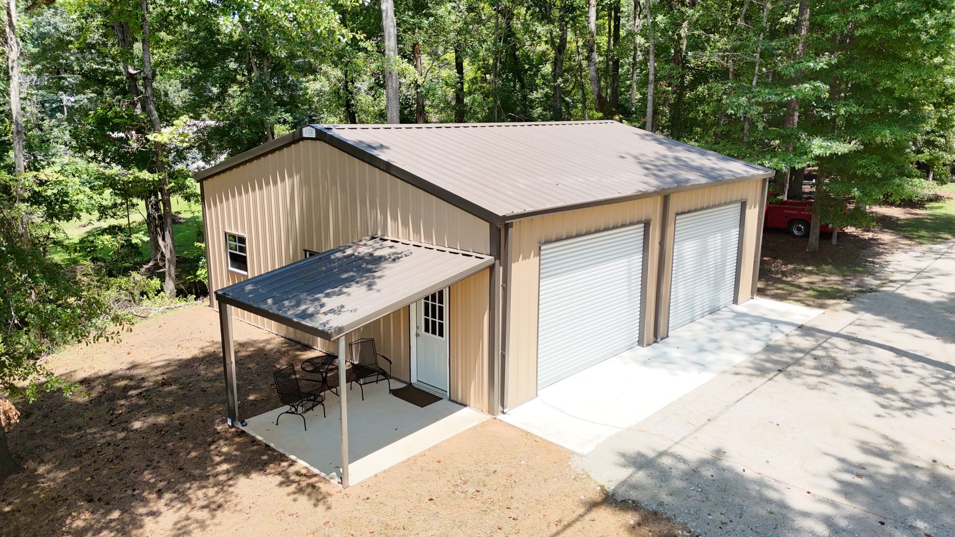 An aerial view of a garage with three garage doors and a porch.