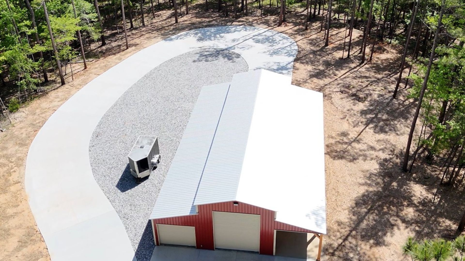 An aerial view of a garage with a car parked in front of it.