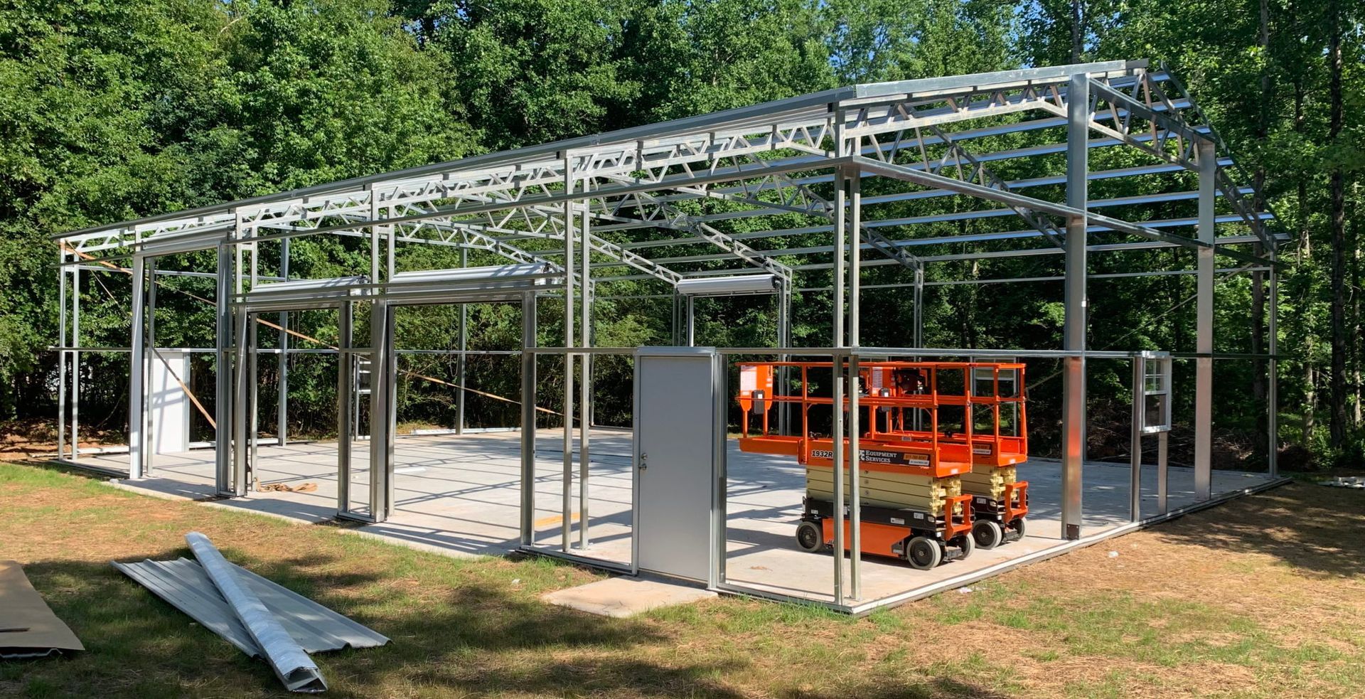 A large metal structure is being built in a backyard.